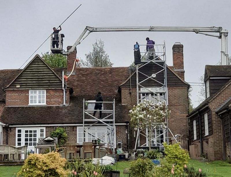 The Roof Moss Cleaners using cherry picker and scaffolding to clean roof safely and professionally in Borehamwood, Hertfordshire
