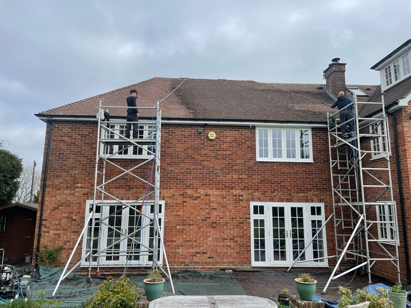 Roof cleaning carried out safely from scaffold towers by The Roof Moss Cleaners in Borehamwood
